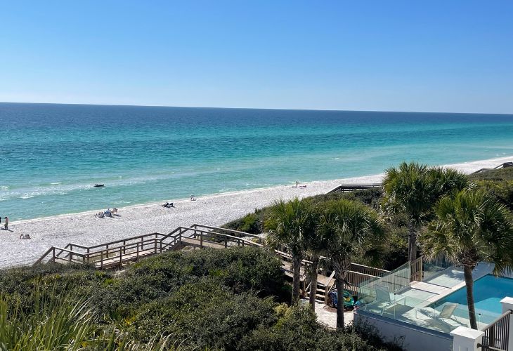 Destin real estate agent​ View of a luxury beachfront property in Miramar Beach, Florida, with a private pool and dune walkover leading to the white-sand beach and emerald Gulf waters.